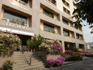 um edifício com flores e plantas em frente em LEE PLACE HOTEL em Banguecoque