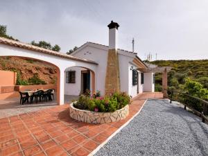 a house with a church and a patio at Belvilla by OYO Casa Guzm n in Árchez