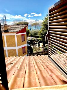 an open door to a backyard with a wooden deck at Garden house in Bolsena