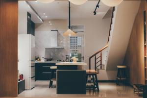 a kitchen with a kitchen island in a room at Lounge away in Taitung City