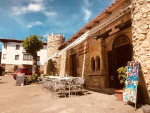 a group of tables and chairs outside of a building at Posada de Bielva in Bielva +15 photos