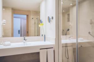 
a bathroom with a sink, shower, and toilet at Iberostar Selection Fuerteventura Palace in Morro del Jable
