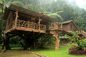 a tree house in the middle of a forest at Safari Resort in Puncak