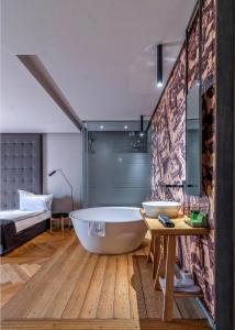 a bathroom with two sinks and a large tub at Design Hotel 36 in Sofia