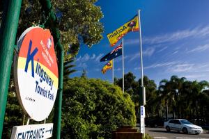 a group of flags flying in a parking lot at Acclaim Kingsway Tourist Park in Perth