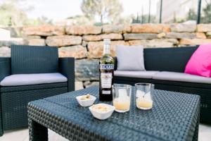 a bottle of wine sitting on a table with two glasses at Villa Marie - Provence Côte d'Azur in Cabasse