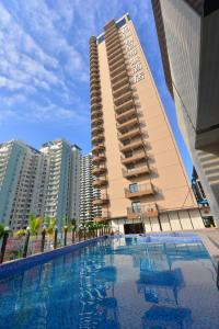 a hotel with a swimming pool in front of a building at Barry Boutique Hotel Sanya in Sanya