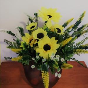 a bouquet of yellow flowers in a brown vase at Apartamento 2 - Fundação de Veiros in Veiros