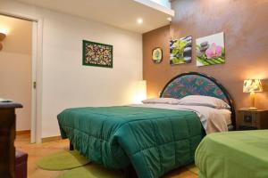 ein Schlafzimmer mit einem Bett mit einer grünen Decke in der Unterkunft MAGICA VISTA in Amalfi