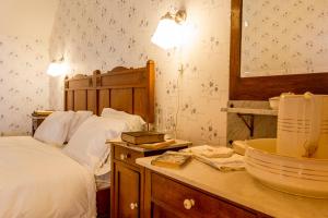 a bedroom with a bed and a counter with a sink at B&B Hostellerie Marie in Eben-Emael