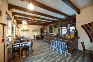 a restaurant with a bar and some tables and chairs at Babushka Noclegi in Białowieża