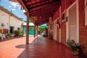 a brick walkway next to a red brick building at Pousada Sucuri in Bonito