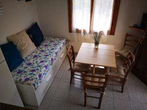a bedroom with a bed and a table with chairs at Il Capperino in Capoliveri