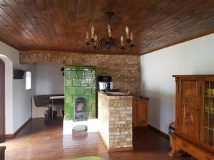 a living room with a fireplace and a piano at Kontyos Vendégház in Felsőtold