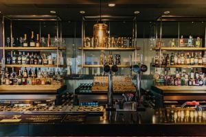 a bar with a lot of bottles of alcohol at Novotel Sheffield Centre in Sheffield