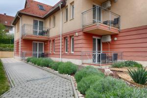 a building with balconies on the side of it at Fortuna 7 Apartments in Hévíz