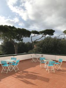 a group of chairs and tables on a patio at Il Miraggio in Fregene