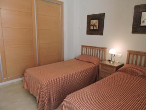 A bed or beds in a room at HL 010 3 bedroom apartment on HDA Golf Resort