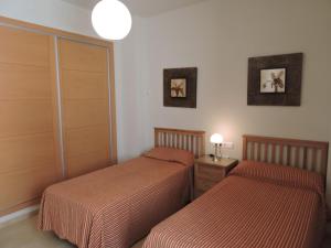 A bed or beds in a room at HL 010 3 bedroom apartment on HDA Golf Resort
