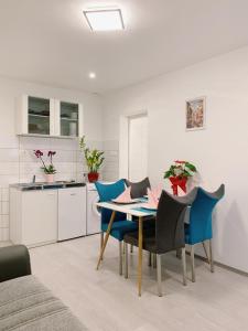 a kitchen and dining room with a table and chairs at LINA ROOMS in Ljubljana