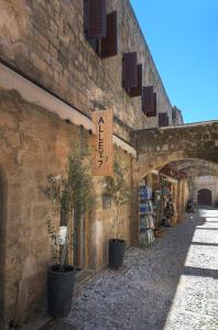 a building with a sign on the side of it at Alley 7, Old Town in Rhodes Town