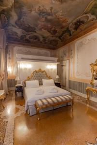 a bedroom with a bed with a painting on the ceiling at Ca' Bonfadini Historic Experience in Venice