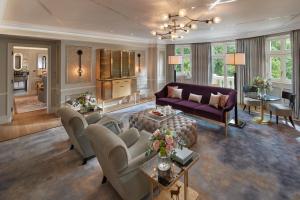 a living room with a couch and a table at Mandarin Oriental Hyde Park, London in London