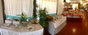 a room with two tables with plants on them at Hotel Spartivento in Chia