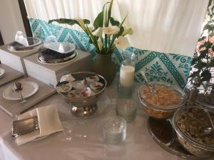 a table topped with plates and bowls of food at Hotel Spartivento in Chia