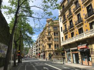 an empty city street with a tall building at Downtown apartment in San Sebastián