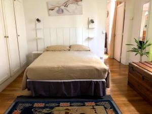 a bedroom with a bed and a rug on a wooden floor at L'appartement Boulnois in Paris