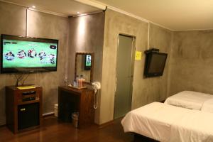 A television and/or entertainment centre at ZIP Hotel