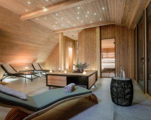 a living room with wooden walls and a wooden ceiling at Boutique hotel Vila Planinka in Zgornje Jezersko