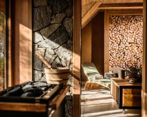 two pictures of a kitchen with a stove and a table at Boutique hotel Vila Planinka in Zgornje Jezersko