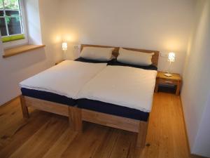 a bed with two pillows on it in a room at Ferienwohnung Schütte-Mühle in Schmallenberg