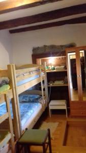 a room with two bunk beds and a desk at Apartmaji pri Živcovih in Dutovlje