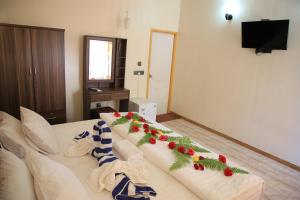 a bedroom with a bed with christmas decorations on it at Evila Inn - Thoddoo in Thoddoo