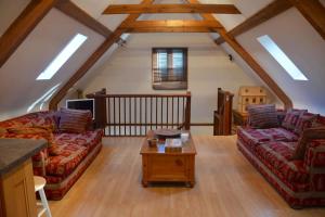 a living room with two couches and a table at The Hideaway-South Downs National Park in Graffham