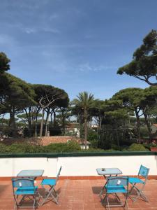 a group of chairs and tables on a patio at Il Miraggio in Fregene