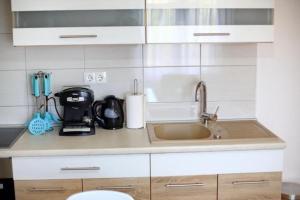 a kitchen counter with a sink and a microwave at Apartmani Sara in Bibinje +40 photos