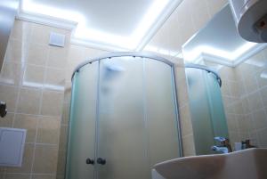 a bathroom with a shower and a sink at Dune Boutique Pomorie in Pomorie