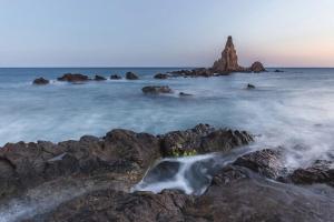 a small waterfall on the rocks in the ocean at Santuario San José in San José