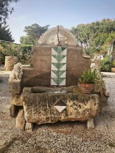 a statue of a bear sitting on top of a bench at Villa Margherita in Favignana