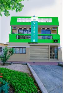 a building with a sign on the side of it at North Star Hostal Guayaquil in Guayaquil