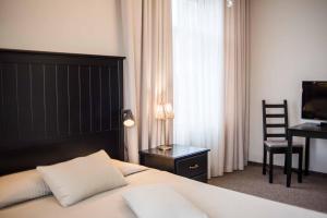 a bedroom with a bed and a desk and a chair at Province in Cēsis