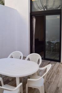 a white table and chairs in a room at NWT Central Station Apartments in Valencia