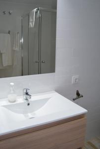 a bathroom with a white sink and a mirror at NWT Central Station Apartments in Valencia