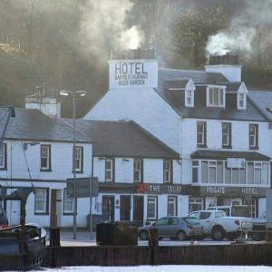 a large hotel with cars parked in front of it at Islay Frigate Hotel in Tarbert