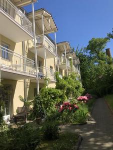 a building with a balcony and flowers in front of it at Apartmenthaus Home24 in Chemnitz