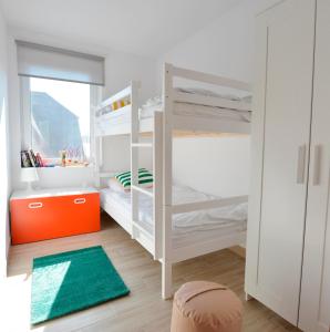 a bedroom with two bunk beds and a green rug at Babie Lato in Łazy